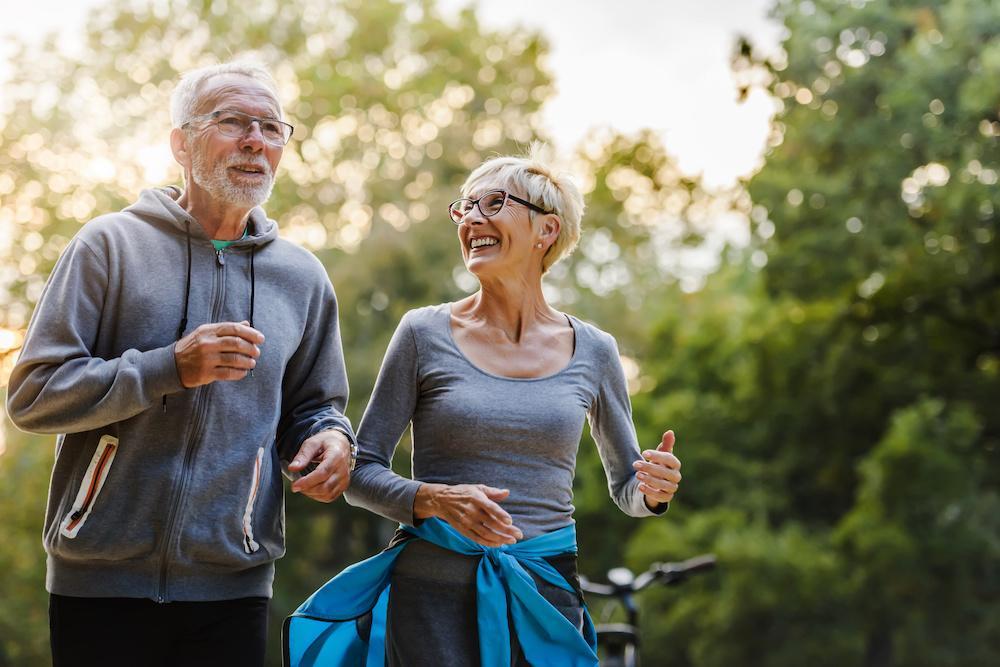 elderly couple going for a jog on a nice summer day